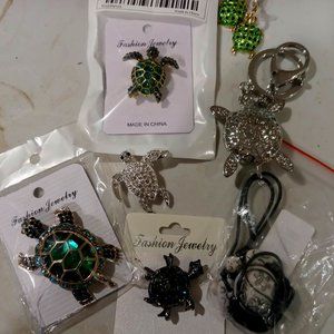 A collection of turtle pins, broches and earrings